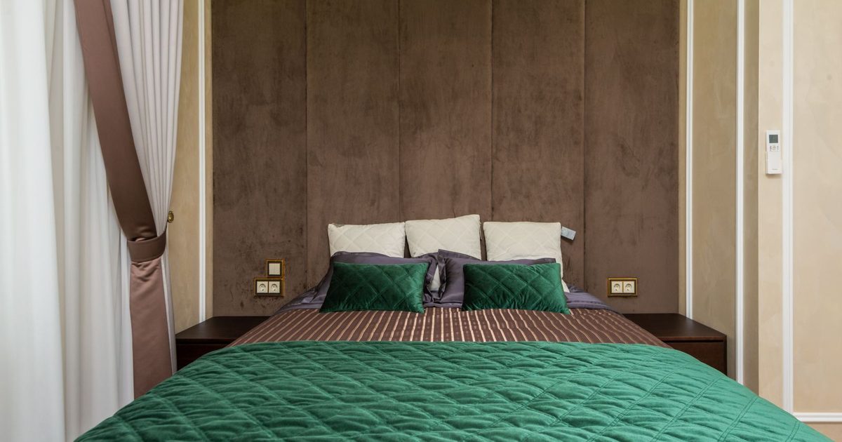 A modern bedroom with green bedding