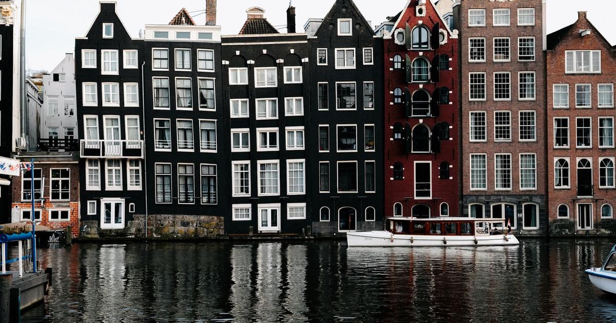 Amsterdam's canal houses reflected in the water