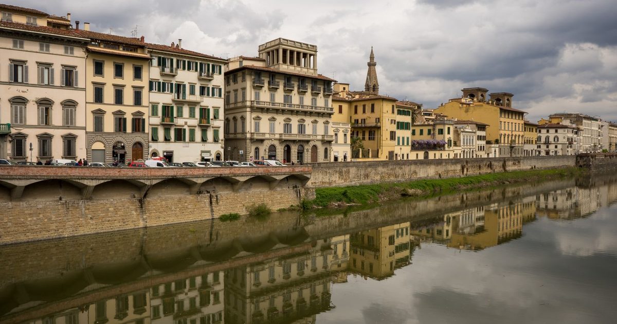Historic buildings reflected in the river in Florence, Italy