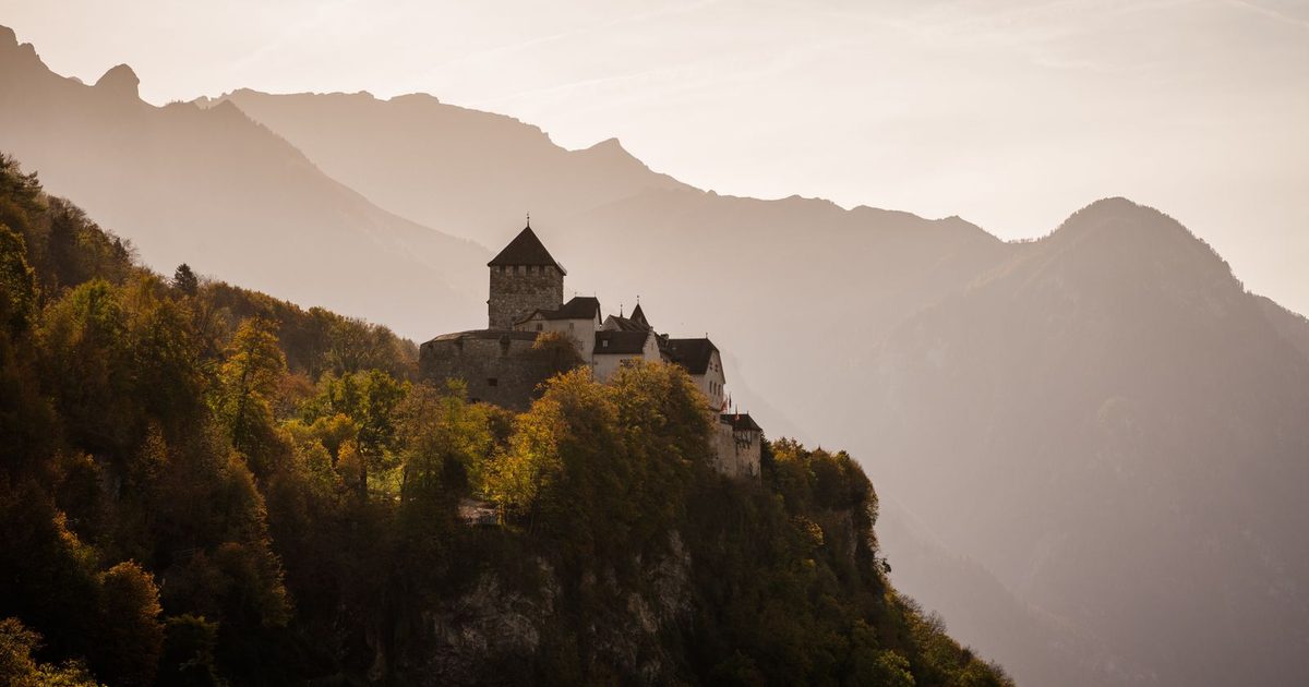 A medieval castle in Vaduz among autumn mountains